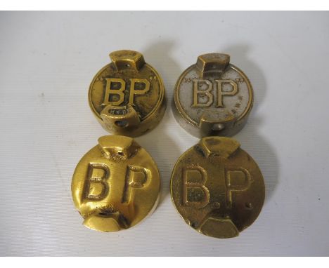 Four BP two gallon petrol can caps, all with different variations. 