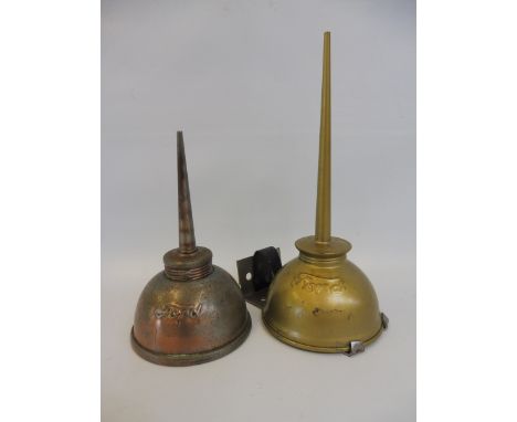Two Ford oil cans, one on a mounting bracket. 
