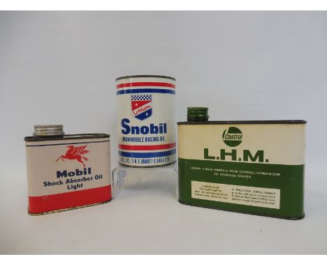 A Mobil Shock Absorber Oil Light can, a Snobil 'Le Mans' oil can and a Castrol L.H.M. can, all in good condition.