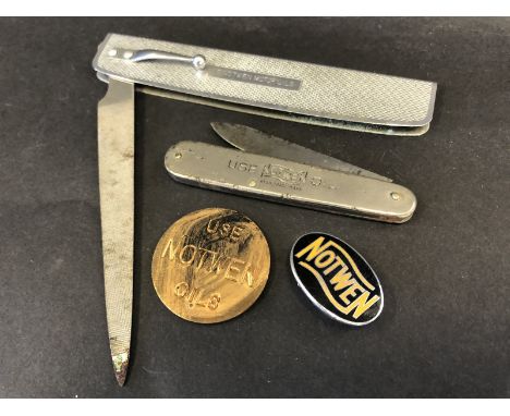 A selection of Notwen oils promotional items including an oval black and orange enamel badge, a penknife, a nail file and a c