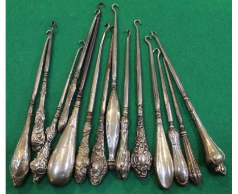 A collection of fourteen silver handled button hooks