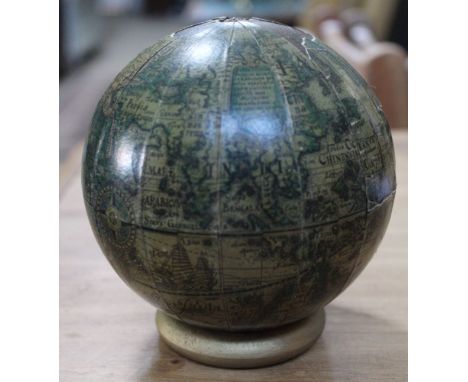 A table globe, the printed papers reveal an early record of the World, approx 12cm (no stand)