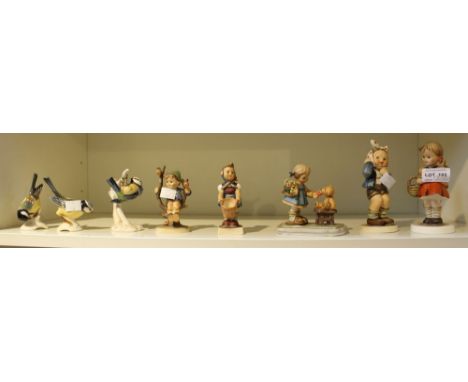 A shelf containing eight Goebel ceramic figurines (8)