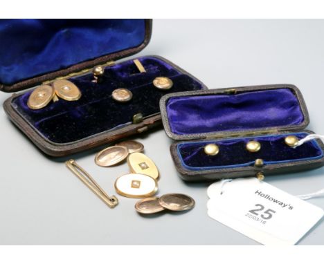 A pair of late Victorian cufflinks, oval with seed pearls to centres, marked '15ct', together with a pair of 9ct gold cufflin