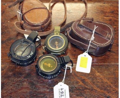 A World War I marching compass, by Cruchon and Emons, in leather case, together with two World War II marching compasses, one