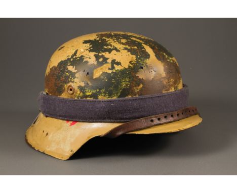 A WWII German M35 steel helmet, with sand colour camouflage and Africa Corps decal with liner and broad bag strap, 30 cm long