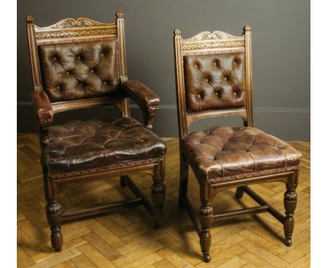 Jas Shoolbred, a set of fourteen oak dining chairs, each having scroll and stiff leaf carved rail, buttoned leather upholster