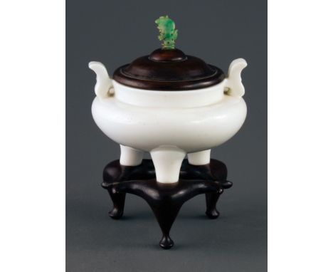 A 19th century Chinese 'jade white' carved Peking glass censer, of pot bellied tripod form, with two shaped handles, now fitt