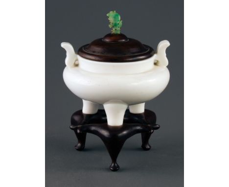 A 19th century Chinese 'jade white' carved Peking glass censer, of pot bellied tripod form, with two shaped handles, now fitt