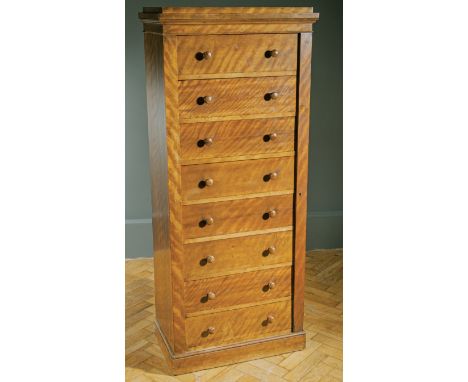 A Victorian figural satin birch caddy topped pedestal Wellington chest, fitted with eight narrow drawers locked by a register