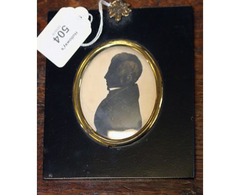 An early 19th century cut card oval silhouette portrait miniature, E Whittle, of a gentleman in high collar and frock coat