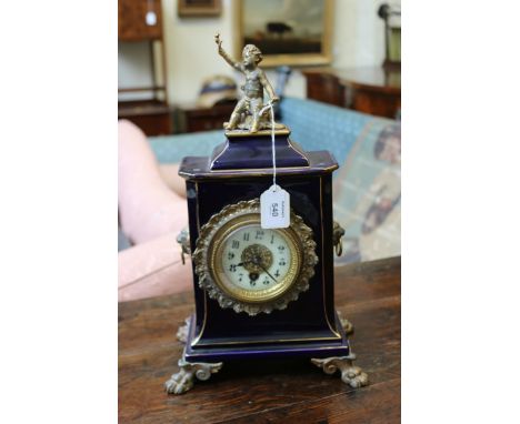 A 19th century French deep blue enamel, gilt line decorated and gilt metal mounted mantel timepiece, the surmount cast as a p