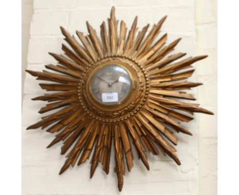 An early 20th century gilt composition sunburst wall timepiece, the eight day French movement faced by engine turned silvered