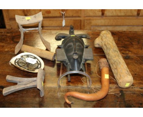 An African wooden tribal mask, with horns and monkey detail, two Ugandan head rest, a kap kap head piece, a penis gourd, Chil