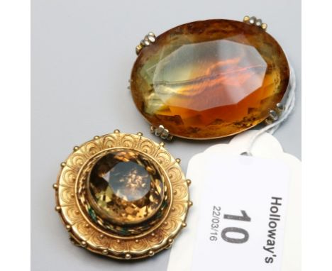 A Victorian 15ct gold and citrine brooch, the large faceted stone with filigree surround and glazed panel to reverse, togethe