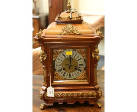 A late 19th/early 20th century mantel clock, the walnut gilt metal mounted three glass case with caddy top enclosing an eight
