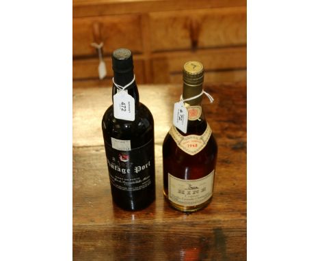 A bottle of 1948 Hine Vieille Grande Champagne Cognac, 70% proof, and a bottle of 1977 Cachao Vintage Port