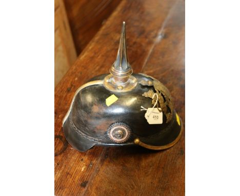 A brass mounted, shaped leather re-enactment Pickelhaube helmet, with chin strip and spire form spike