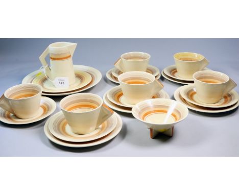 A matched 1930's Clarice Cliff Bizarre tea service, comprising six cups and a jug, each with solid triangular handle, conical