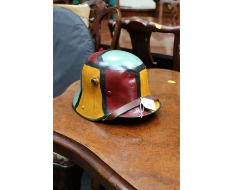 A WWI German M16 steel helmet, with abstract camouflage finish, with liner, 30 cm long