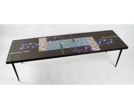 A mid 20th Century occasional table by John Piper, the surface having inset multi coloured mosaic tiles, all on a tubular ste