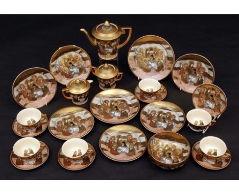 An early 20th Century Japanese satsuma pottery tea set decorated with a gilt and enamel immortal figural design, comprising o