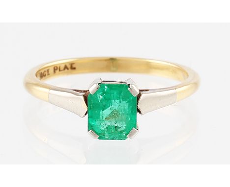 An 18ct yellow gold emerald ring, claw set with a single central emerald cut emerald measuring approx. 6x5mm, set into a plat