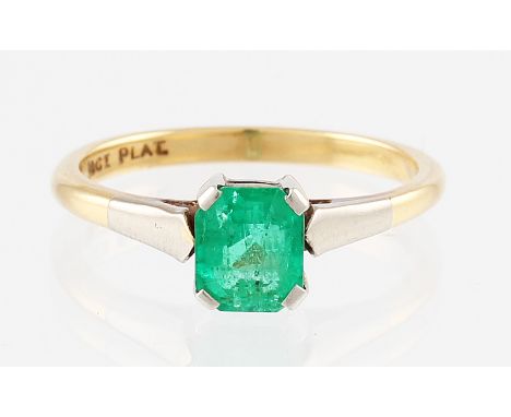 An 18ct yellow gold emerald ring, claw set with a single central emerald cut emerald measuring approx. 6x5mm, set into a plat