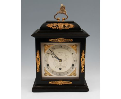 An Elliot of London bracket clock in Georgian style with ebonized body with gilt coloured decoration plus silvered face and c