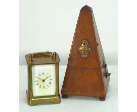 WATERBURY CLOCK CO. AMERICAN PATENTED CARRIAGE CLOCK, of typical form, with white Roman mask and top carrying handle to the c