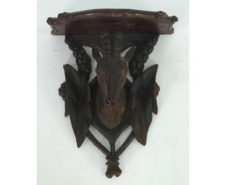 EARLY TWENTIETH CENTURY BLACK FOREST CARVED SOFTWOOD WALL BRACKET, carved with a stags head, 8" (20.3cm) high, 6 3/4" (17.2cm