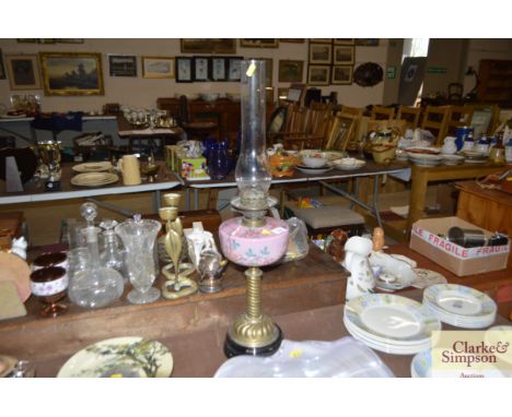 A Victorian pink glass and brass table oil lamp