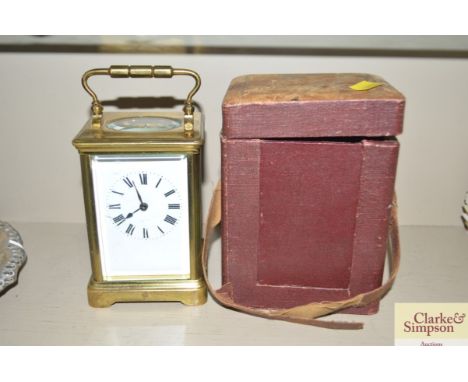 A brass cased carriage clock with carrying case