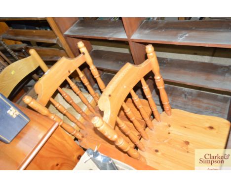 A pair of modern pine stick back kitchen chairs; and a rush seated similar 