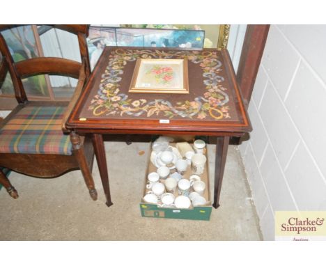 An embroidered folding card table