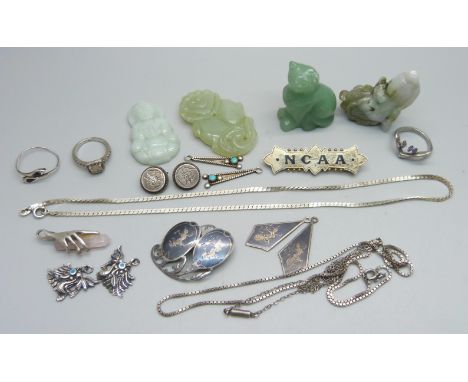 A hallmarked silver brooch, Birmingham 1901, marked NCAA, other silver jewellery, three jade pendants and a carved cat figure