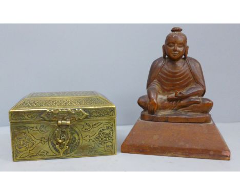 An Asian brass box and a carved wooden model of a seated Buddha 