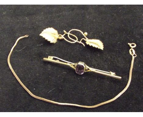 Yellow metal pin brooch with central amethyst, together with a pair of yellow metal leaf earrings and a small 9ct gold bracel