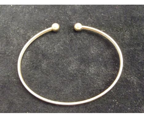 Yellow metal bangle, tested for gold. Weight 3.6 grams 