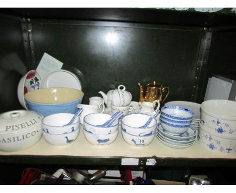 A shelf of miscellaneous including rice bowls and spoons