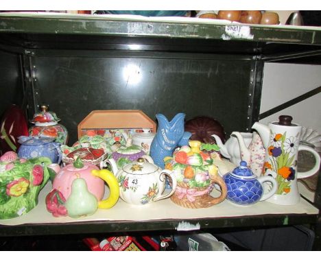 A shelf of assorted teapots