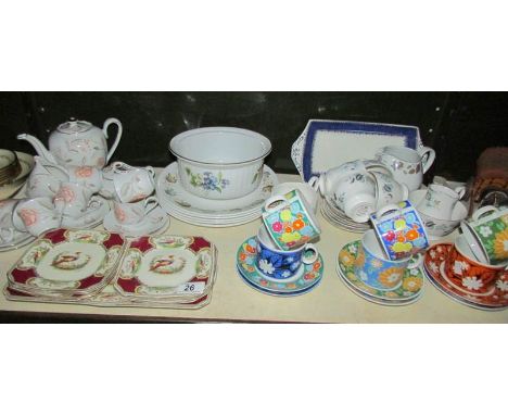 A shelf of assorted tea ware