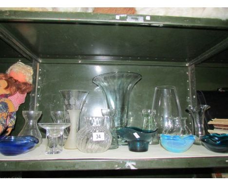 A shelf of assorted glass ware