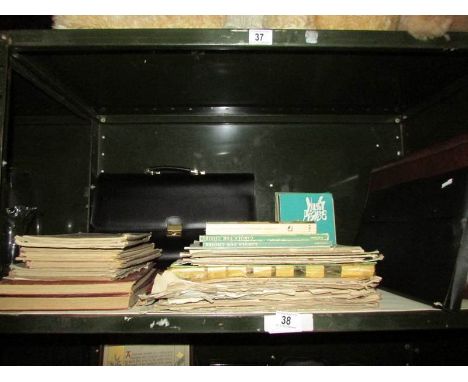 A shelf of miscellaneous music books, brief cases etc