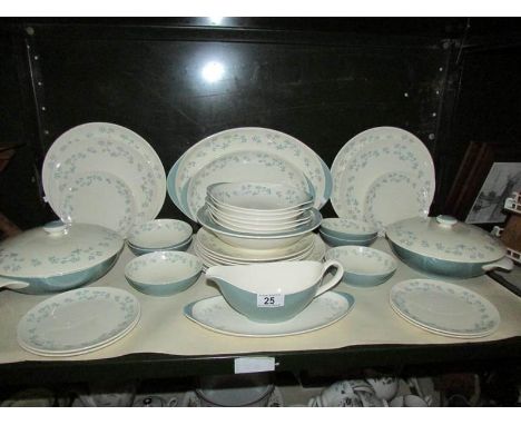 A shelf of Royal Doulton April Showers pattern dinner ware