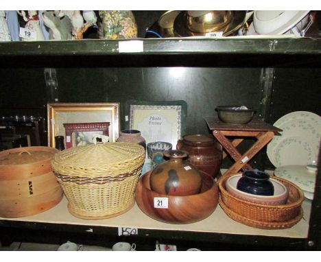 A shelf of assorted wooden items, photo frames etc