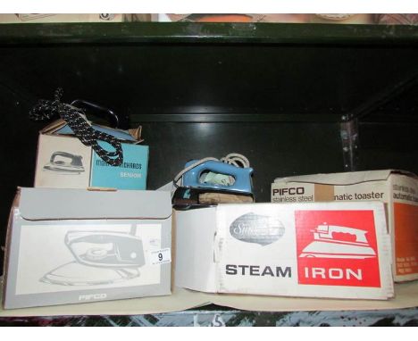 A shelf of electric irons etc