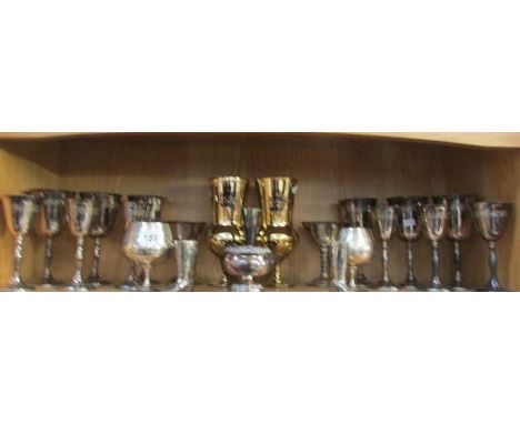 A shelf of metal goblets, tankards etc