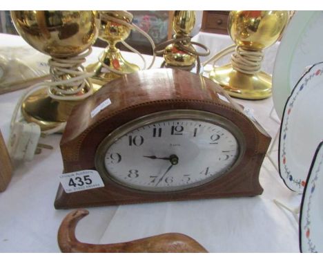 A mahogany inlaid mantel clock