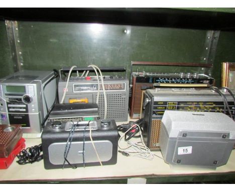 A shelf of various radio's etc